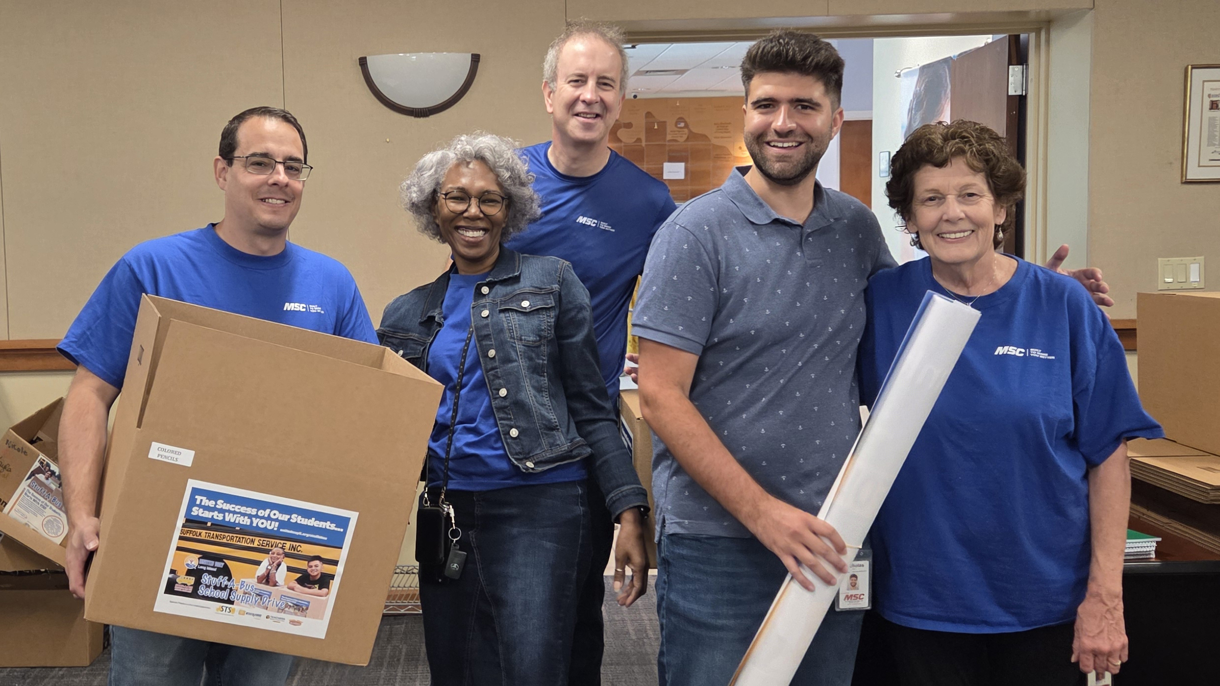 Community Relations Associates - Melville Associates Pack School Supplies with United Way of Long Island