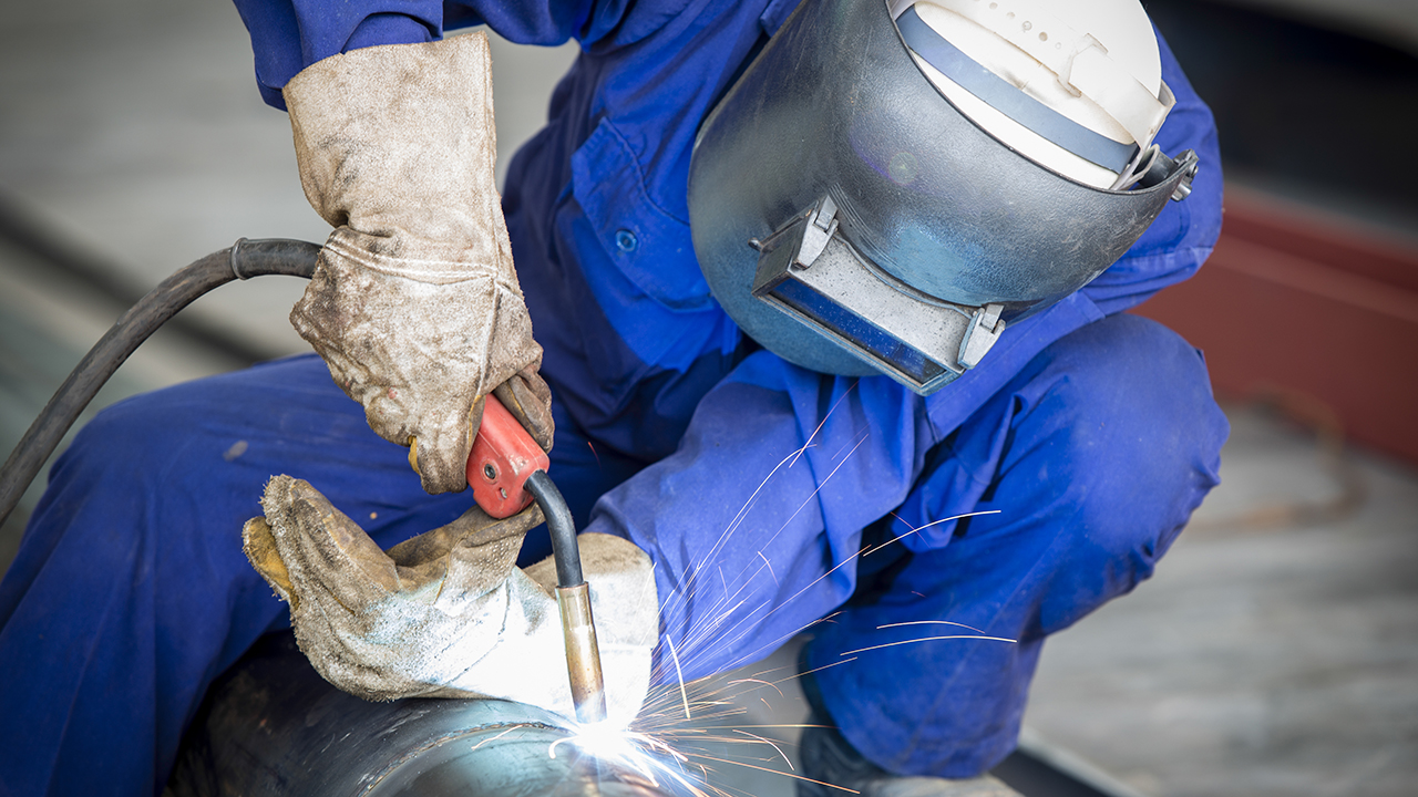 Man welding wearing protective equipment
