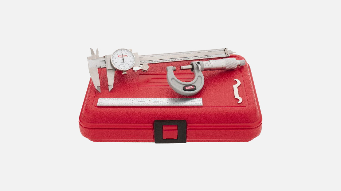SPI precision measuring tool set with dial caliper, micrometer, and ruler on top of a red carrying case
