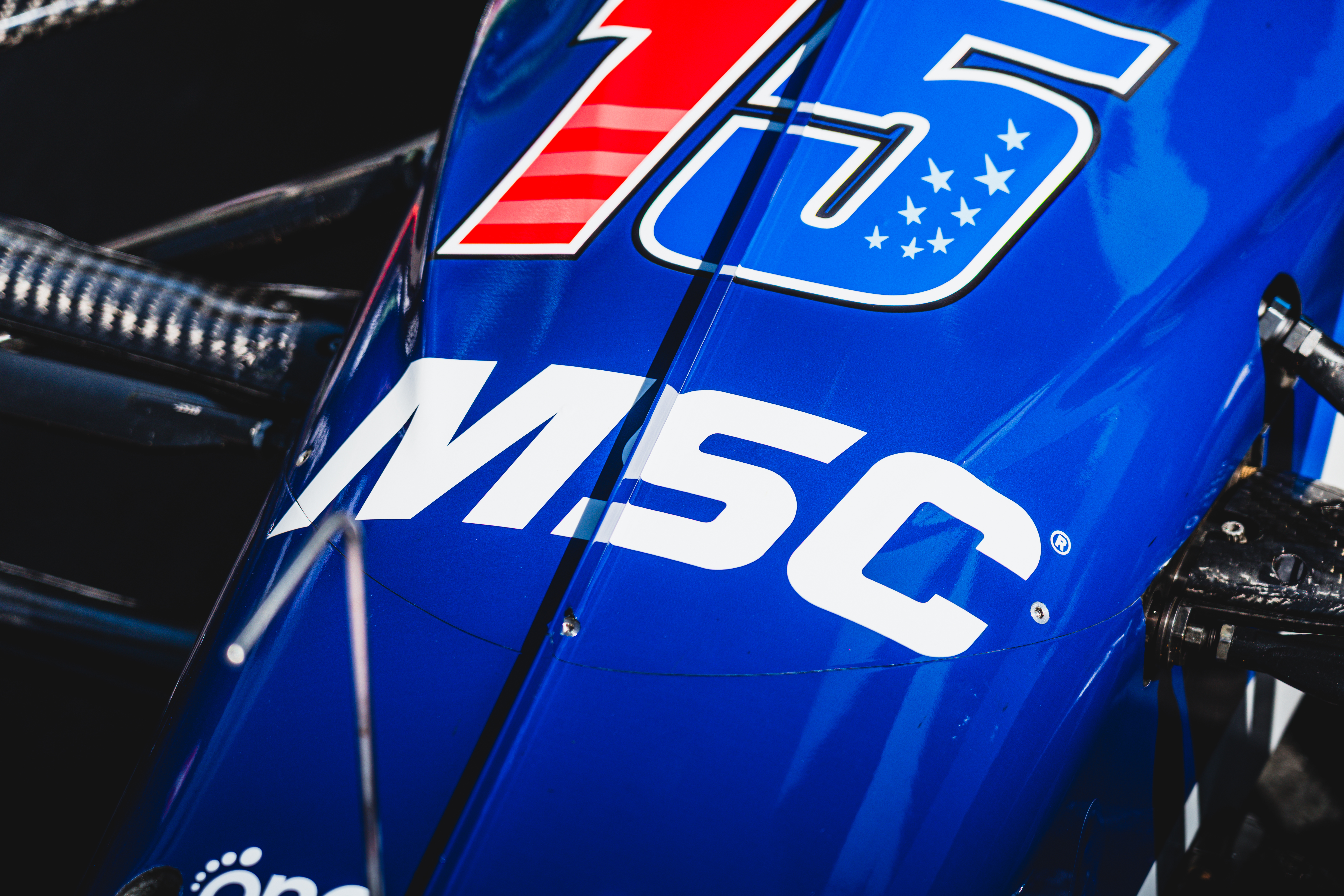 Blue racing vehicle panel displaying MSC logo with red, white, and blue number 15 design and stars