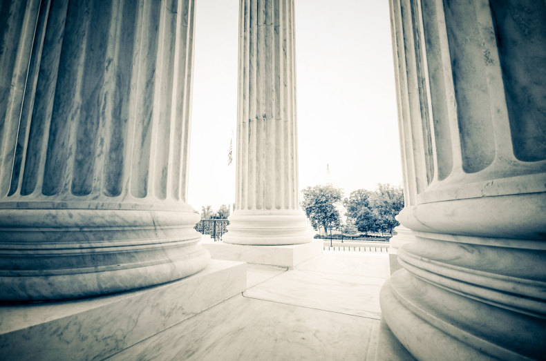 Looking out from inside the pillars in front of the U.S. Supreme Court.