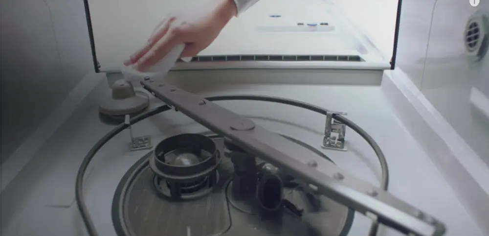 Cleaning soils out of bottom of dishwasher