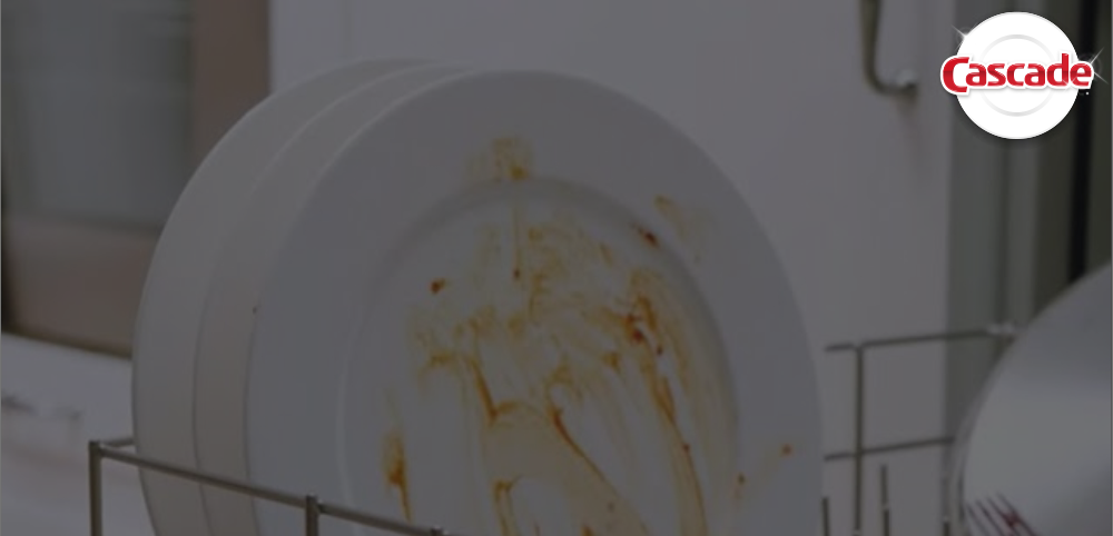 Dirty plate loaded inside dishwasher bottom rack