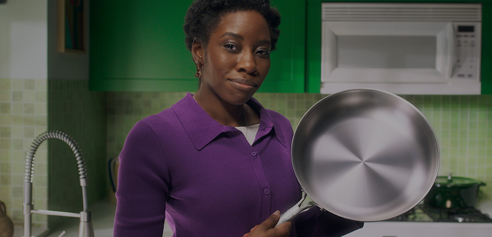 Woman in a kitchen with the pan