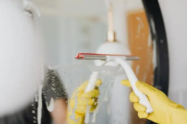 A lady cleaning a bathroom