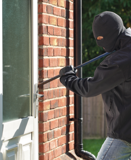 Image of a burglar attempting to break into a property at city plumbing  