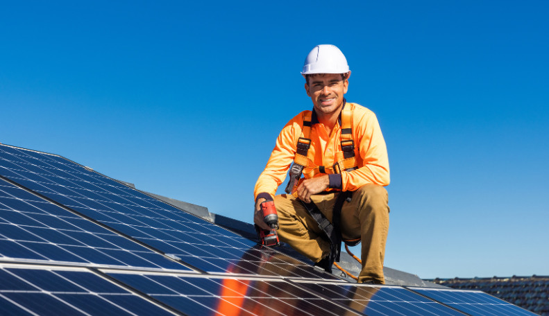 image of an installer installing solar panels on a home