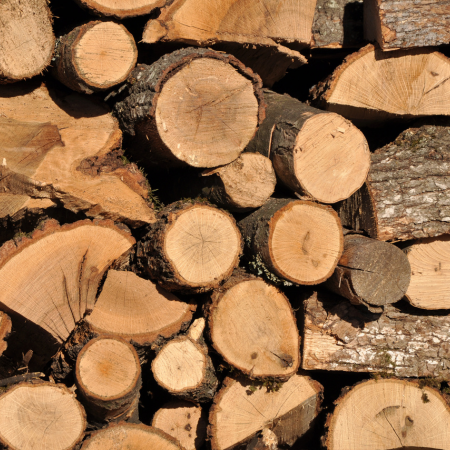 Image of a stack of logs ready for biomass heating at city plumbing