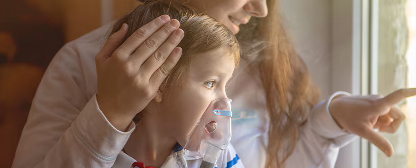 child wearing a nebulizer