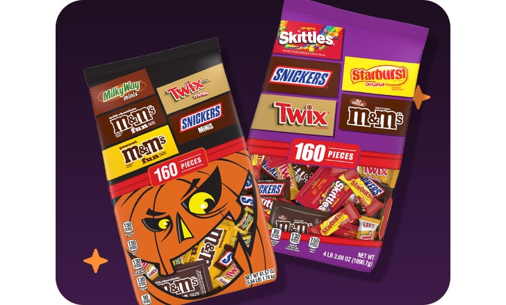 Hershey's big bags of Halloween candy against a dark background with orange stars