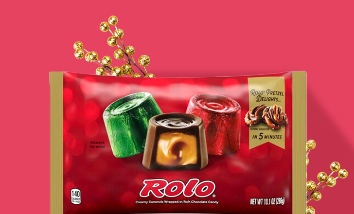 Bag of Rolo chocolates in festive red and green wrappers against a red background.