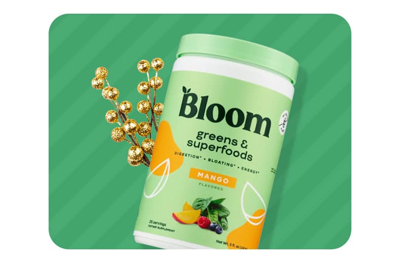 A container of Bloom greens & superfoods mango flavored powder.