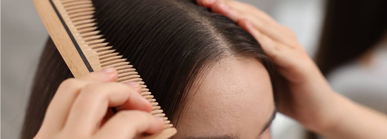 Woman combing her hair.