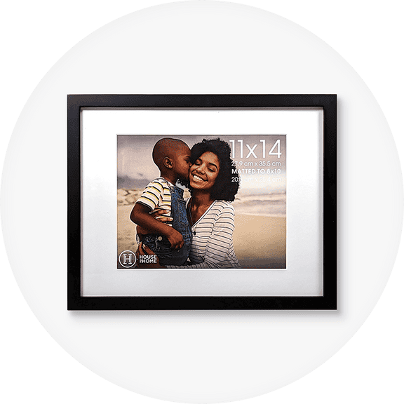 11 by 14 black picture frame with a stock image of an adult hugging a child in overalls on the beach