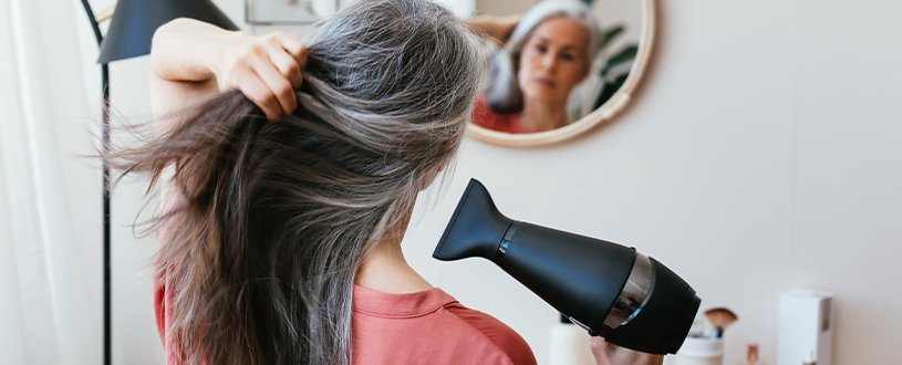 Woman blow-drying her hair