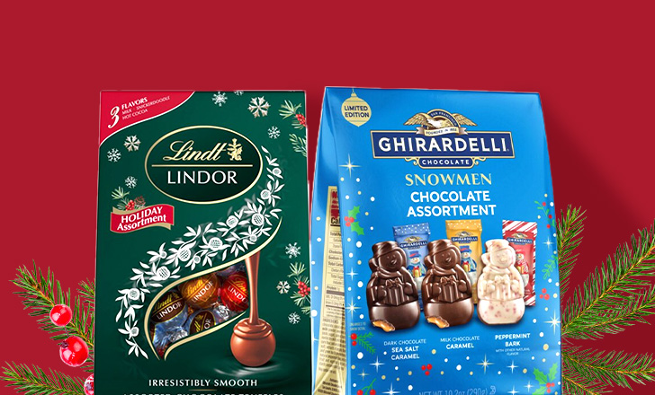 Lindt and Ghirardelli holiday chocolate boxes against a festive red background.