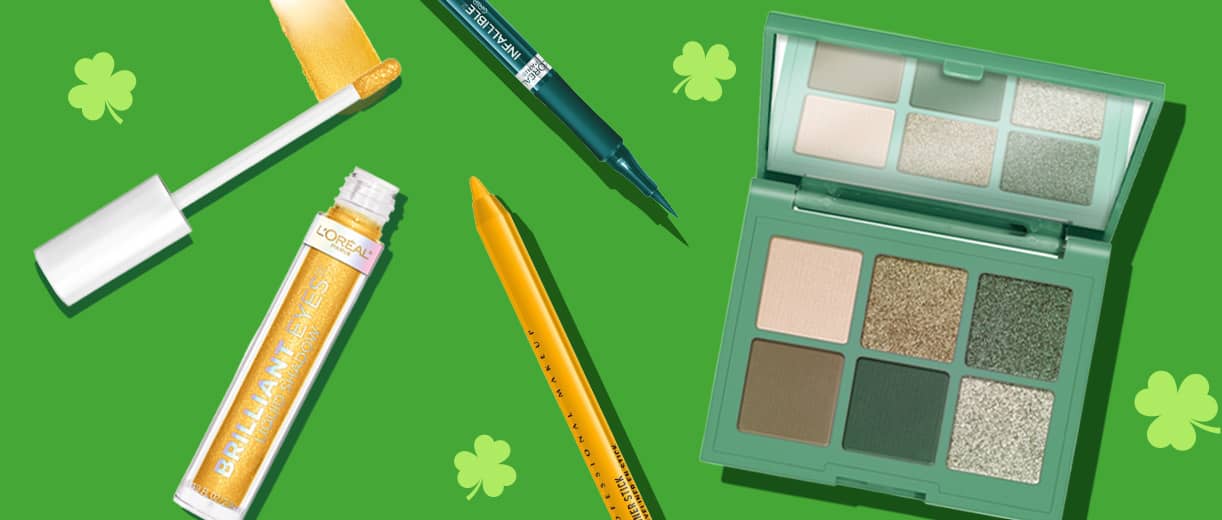 Assorted eye makeup products with shamrocks in the background