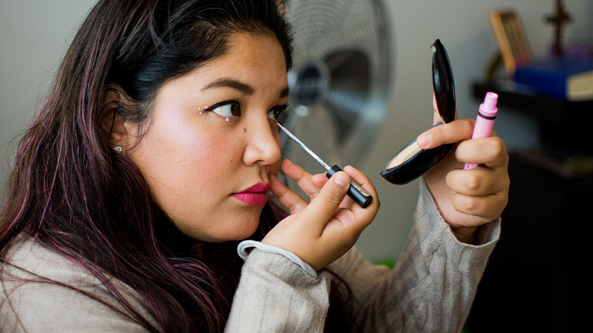 Woman putting on makeup