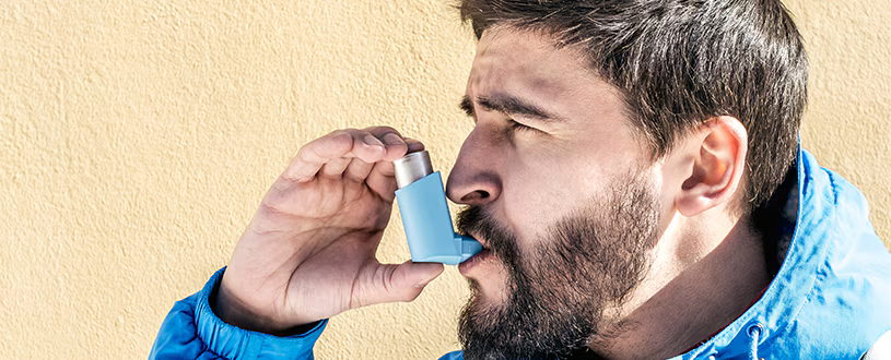 Man using an inhaler