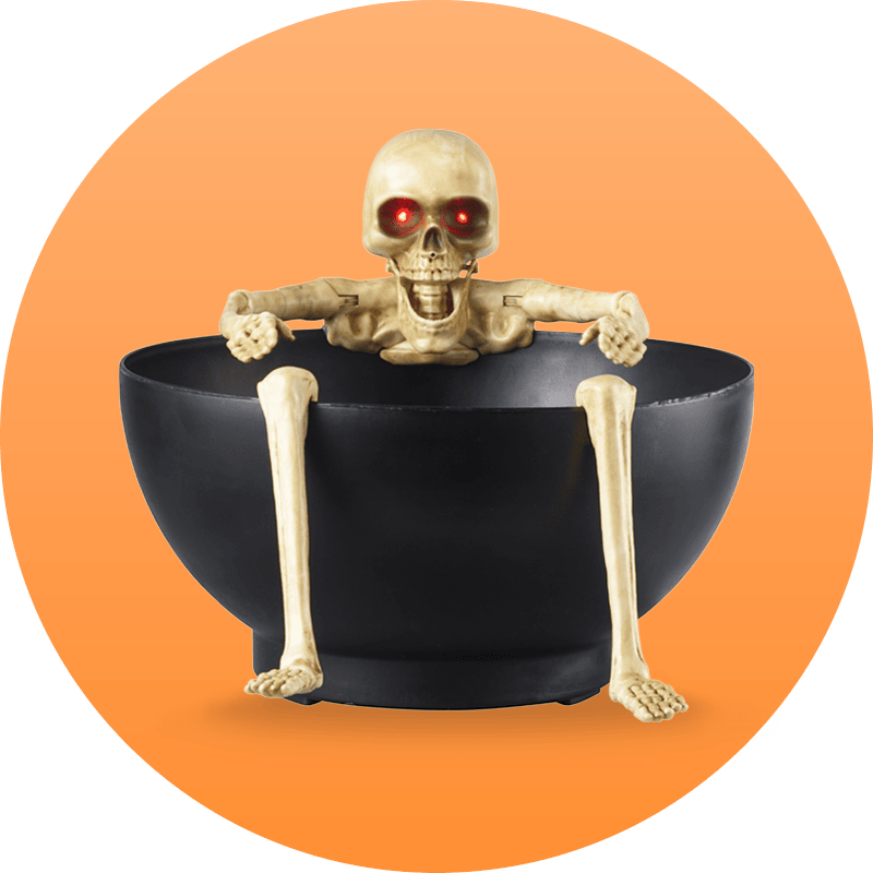 Halloween-themed candy bowl with a skeleton sitting on it