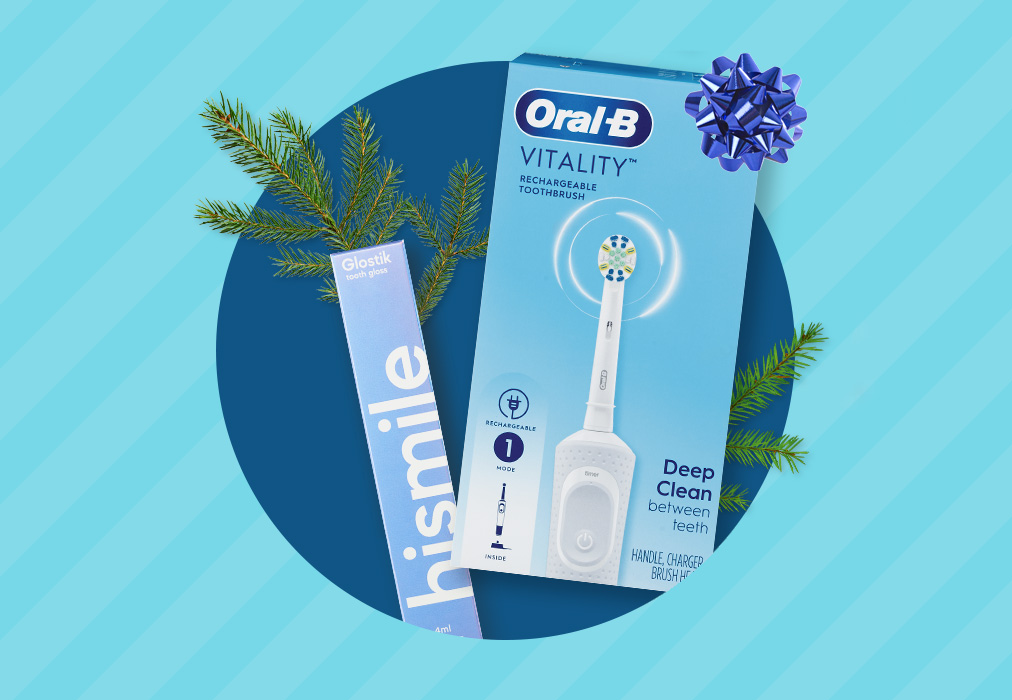 A box of Hismile Glosstik and a boxed Oral-B Vitality power toothbrush.