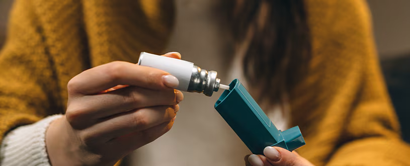 person using an inhaler