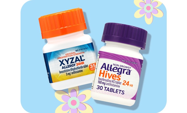 Xyzal allergy tablets and Allegra Hives tablets against a blue background and pastel-colored flowers