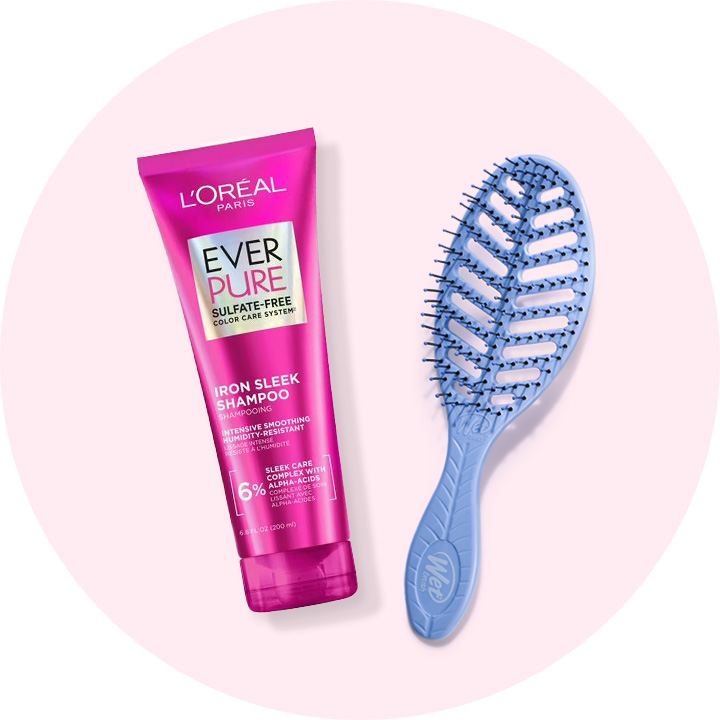 Bottle of L'Oreal Paris Ever Pure shampoo and a detangling hair brush