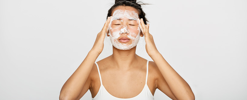 Woman exfoliating her face