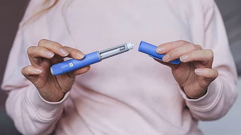 person holding glp-1 injector