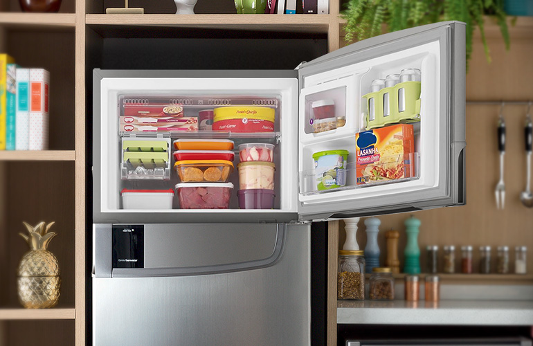 Freezer com porta aberta cheio de alimentos.
