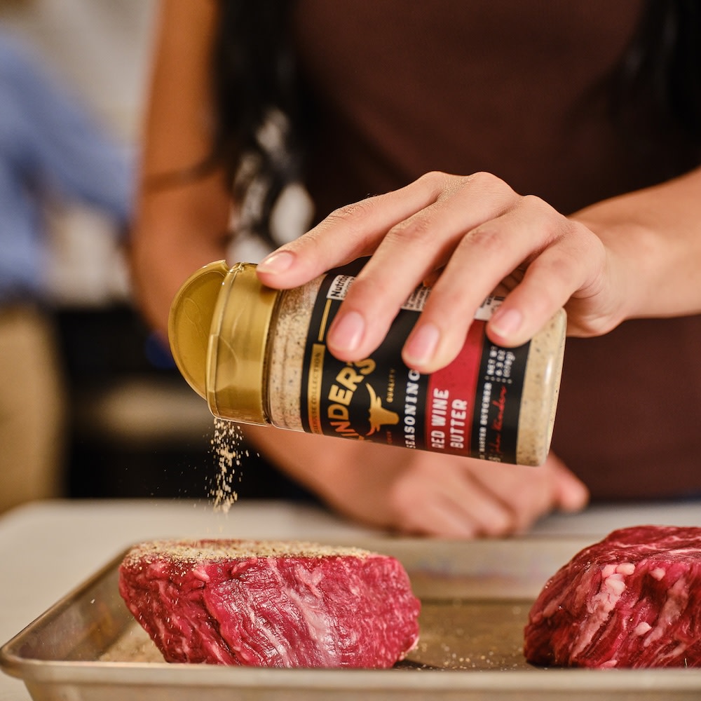 Sprinkling filet mignon with Red Wine Butter seasoning 