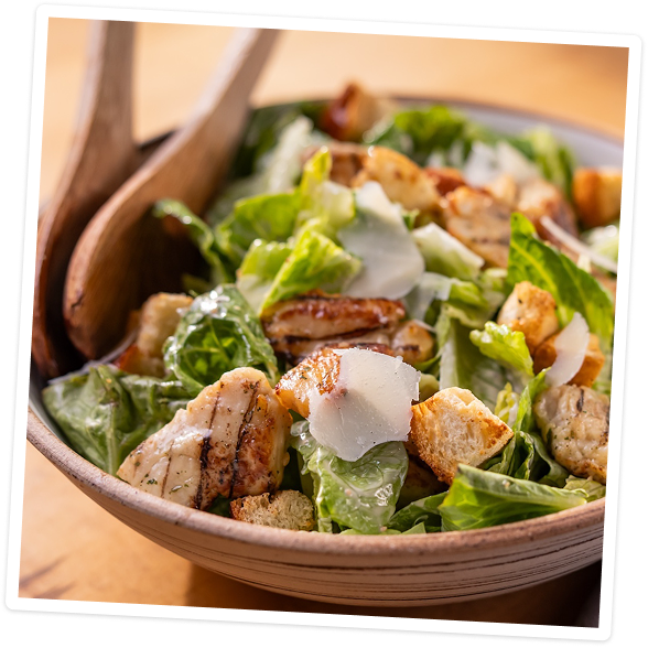 Grilled chicken bites in a Caesar salad