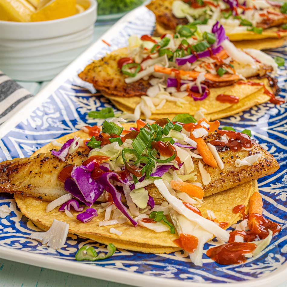 Plate of grilled fish tacos with cabbage topping