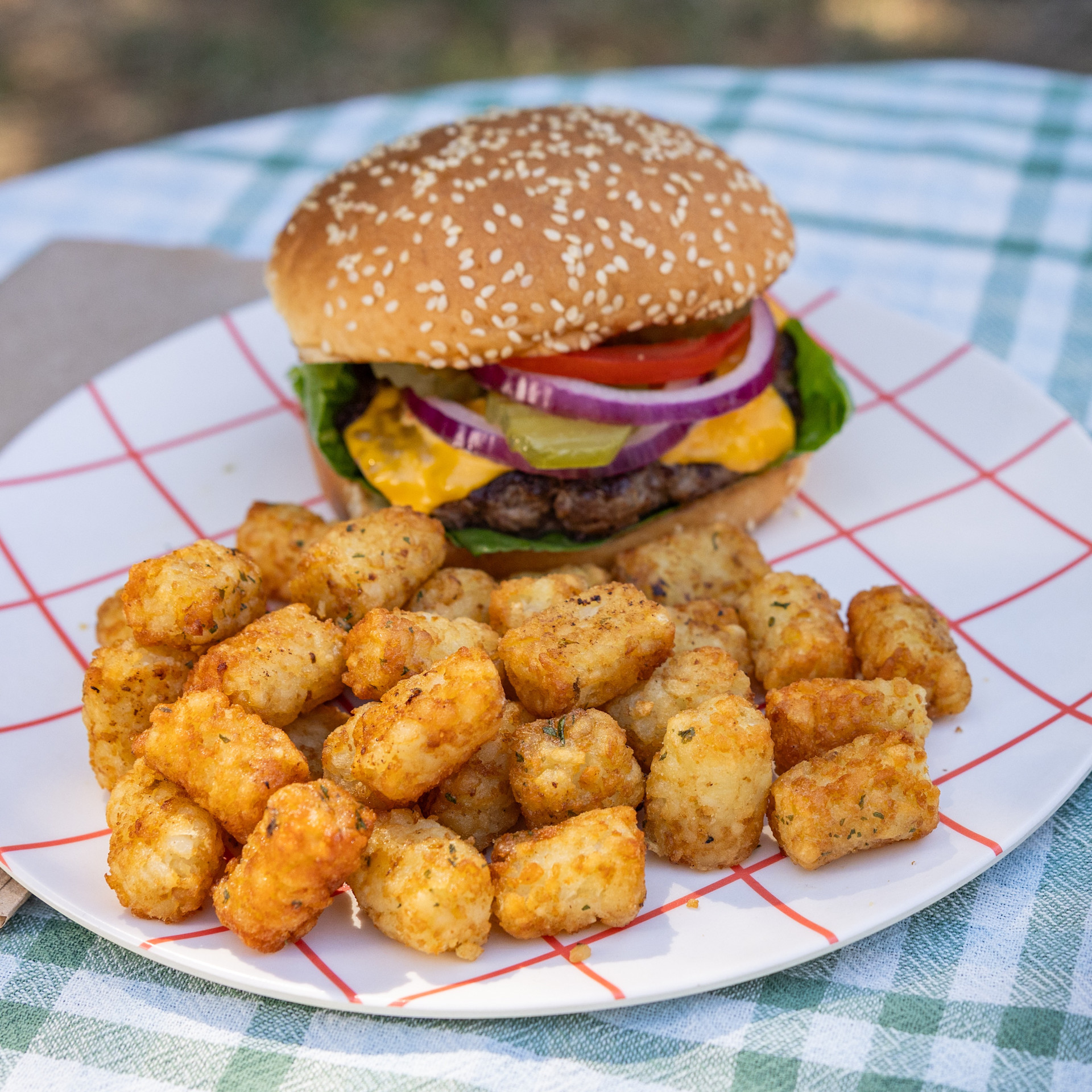crispy tots with a burger and side of BBQ sauce