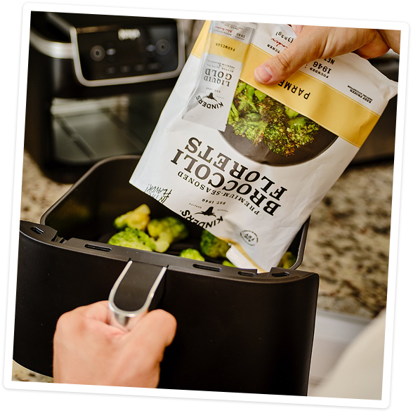 Putting frozen broccoli into the air fryer