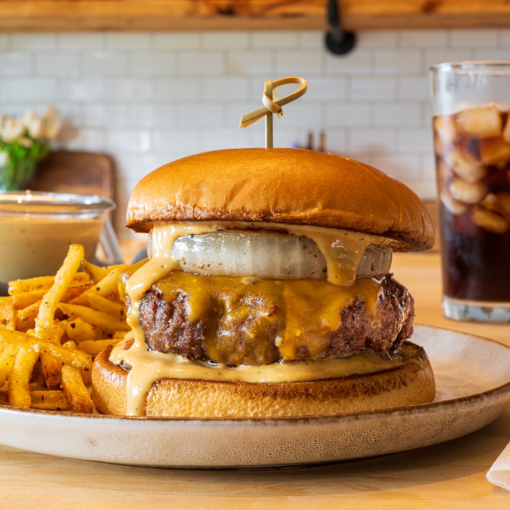 Cheeseburger with burger sauce and fries on a plate