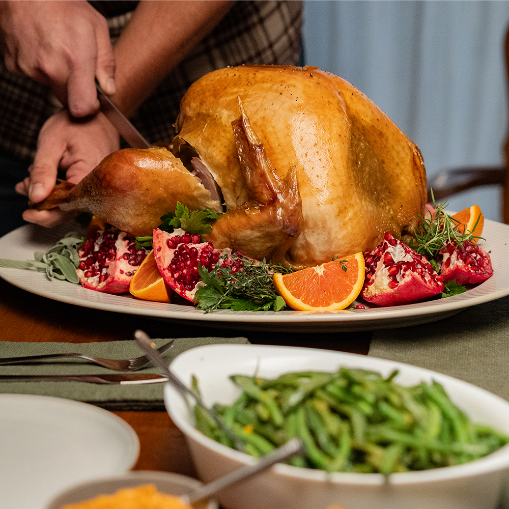 Roasted turkey on a table with green beans