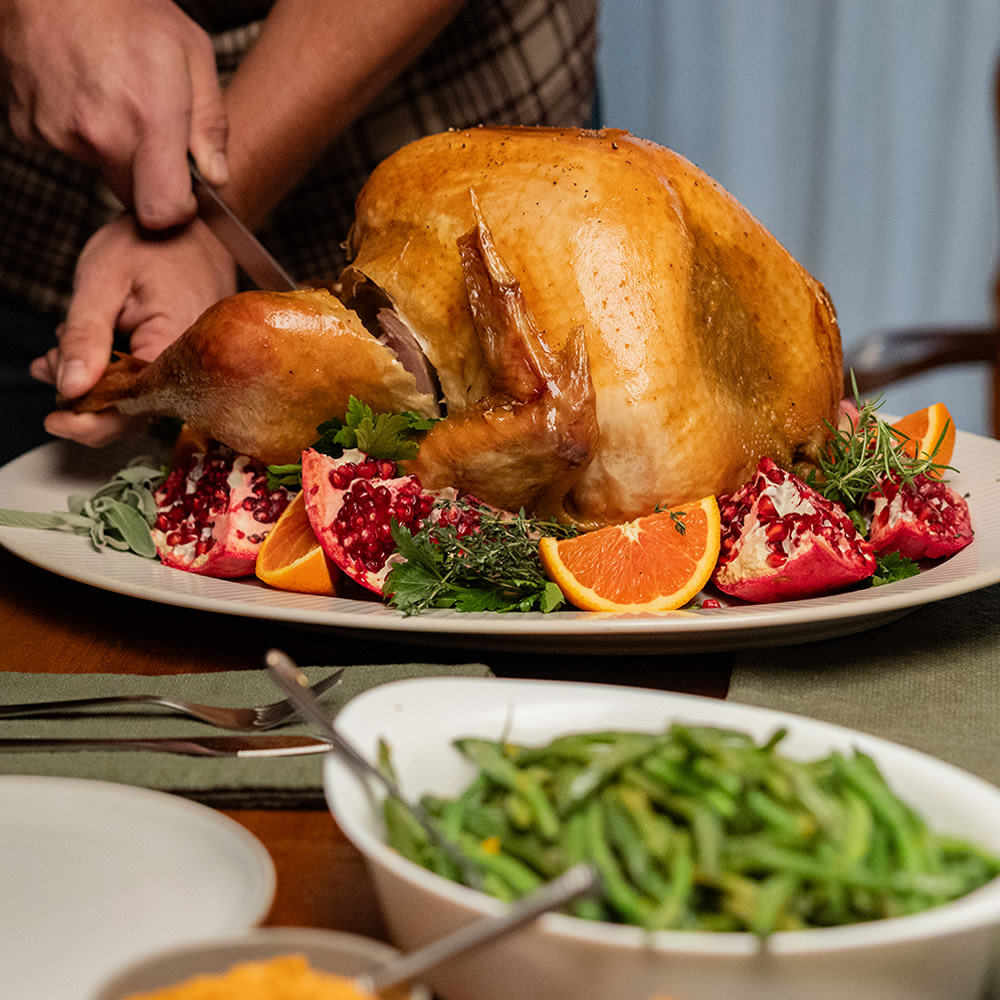 Roasted turkey on a table with green beans
