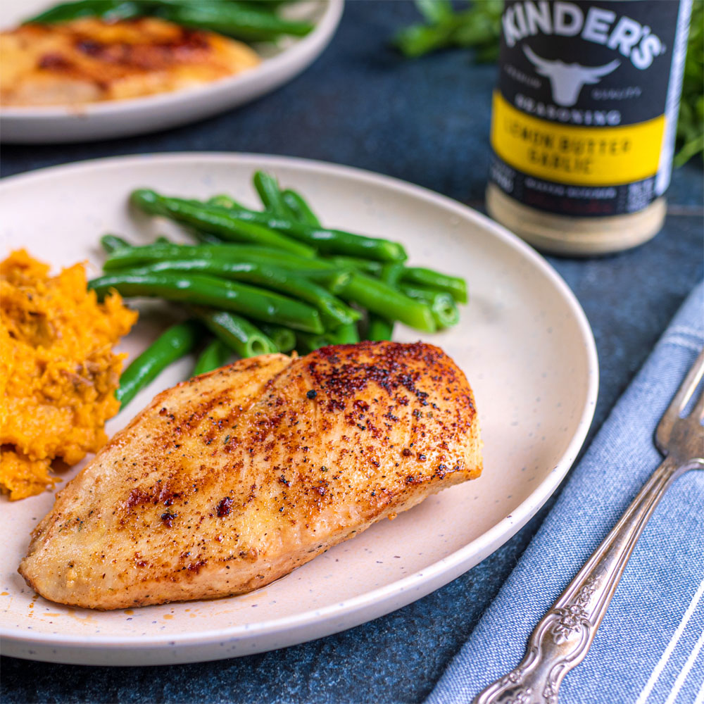 Seasoned chicken on plate with vegetables