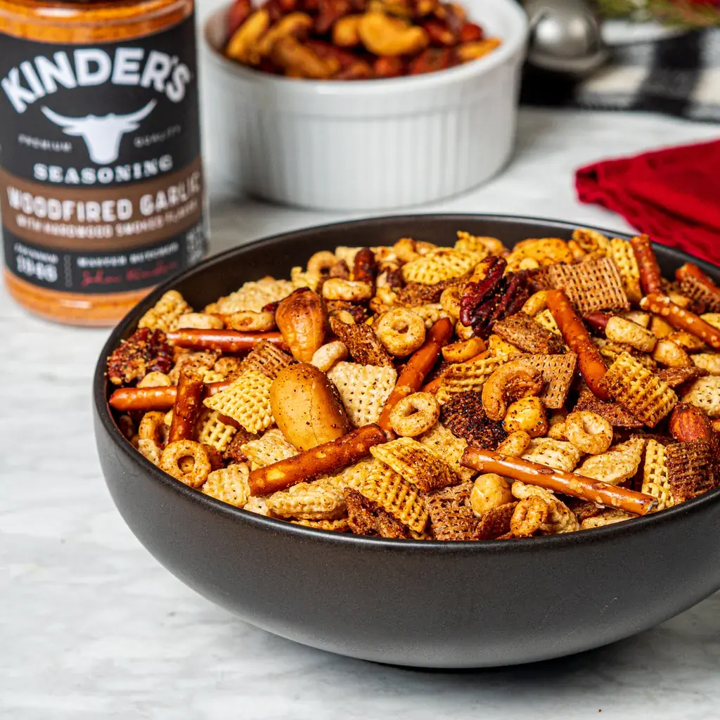 Bowl of party mix with chex pretzels nuts and cereal