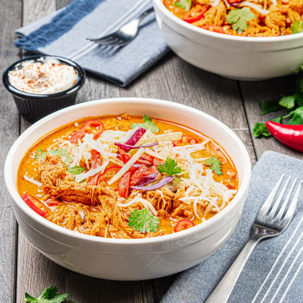 Bowl of chicken chili with toppings