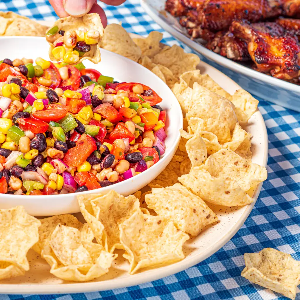 Bowl of tomatoes corn beans peppers and tortilla chips for dipping