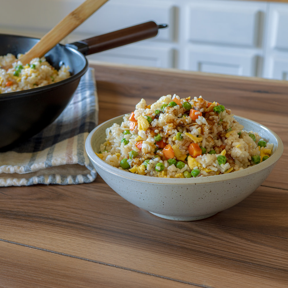 Fried rice with egg, carrot, and peas in a bowl