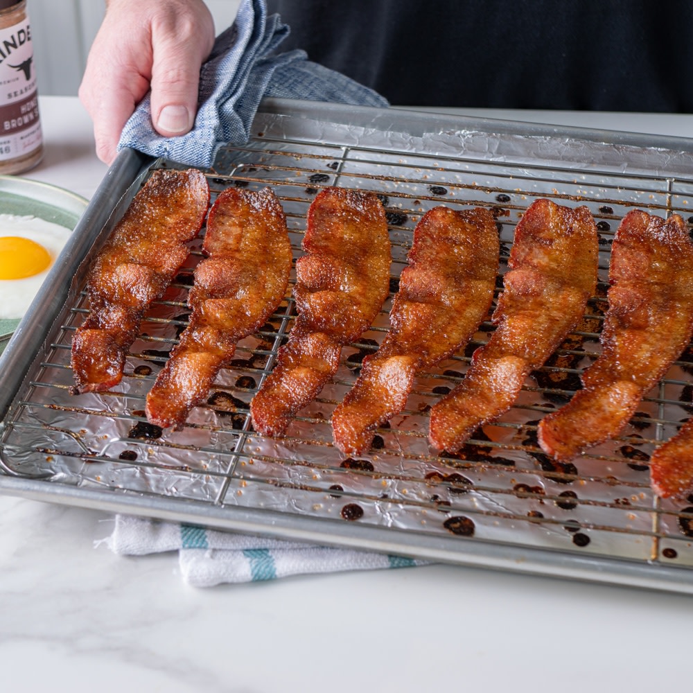 Candied bacon on a wire rack on a sheet pan