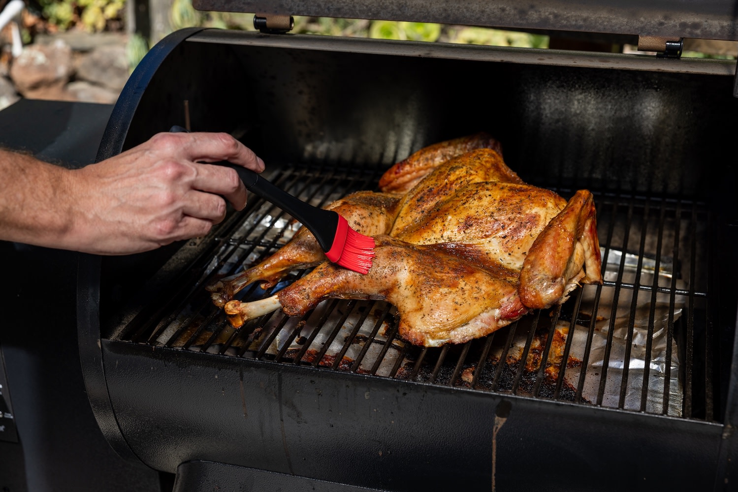 whole smoked turkey on a grill