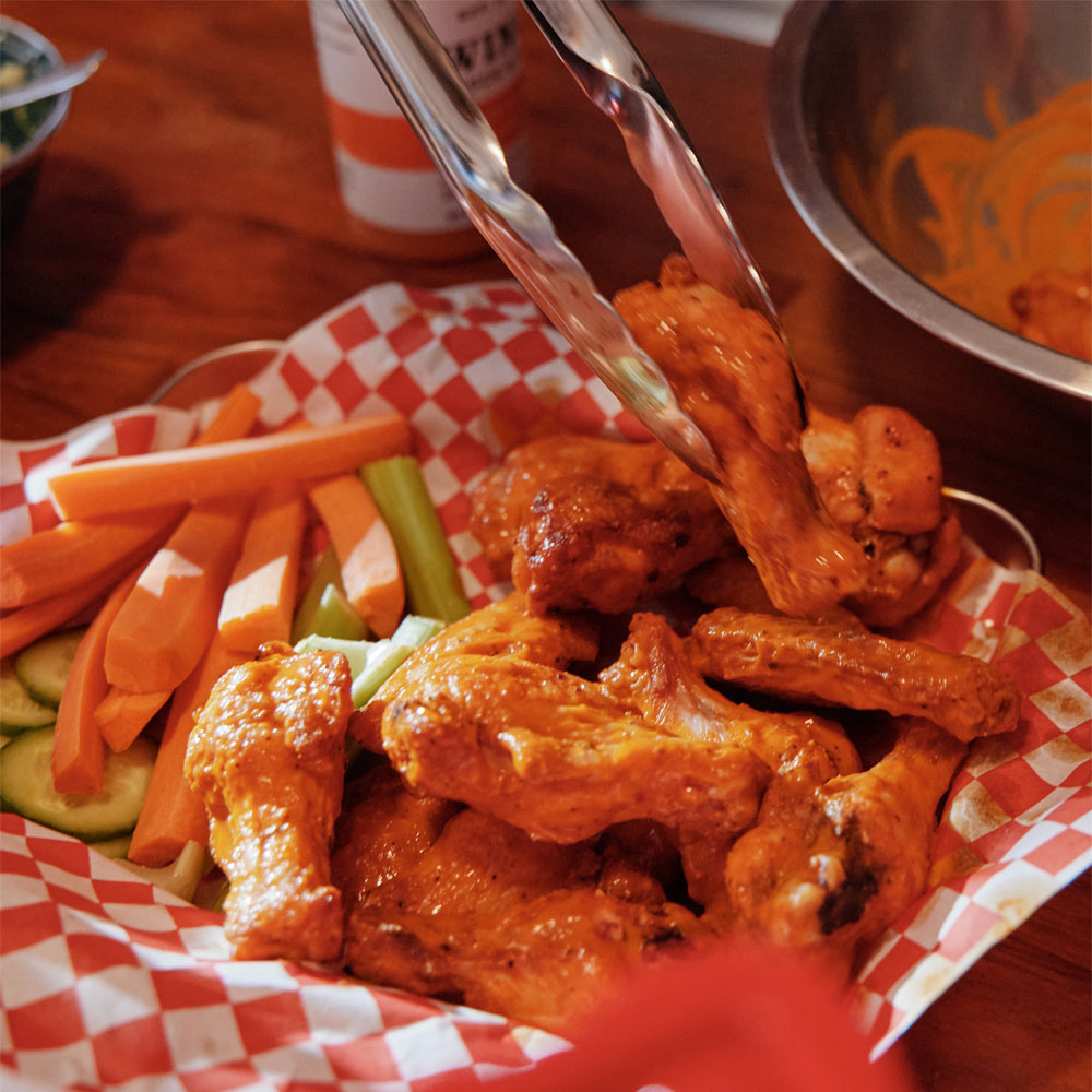 sauced chicken wings with veggies