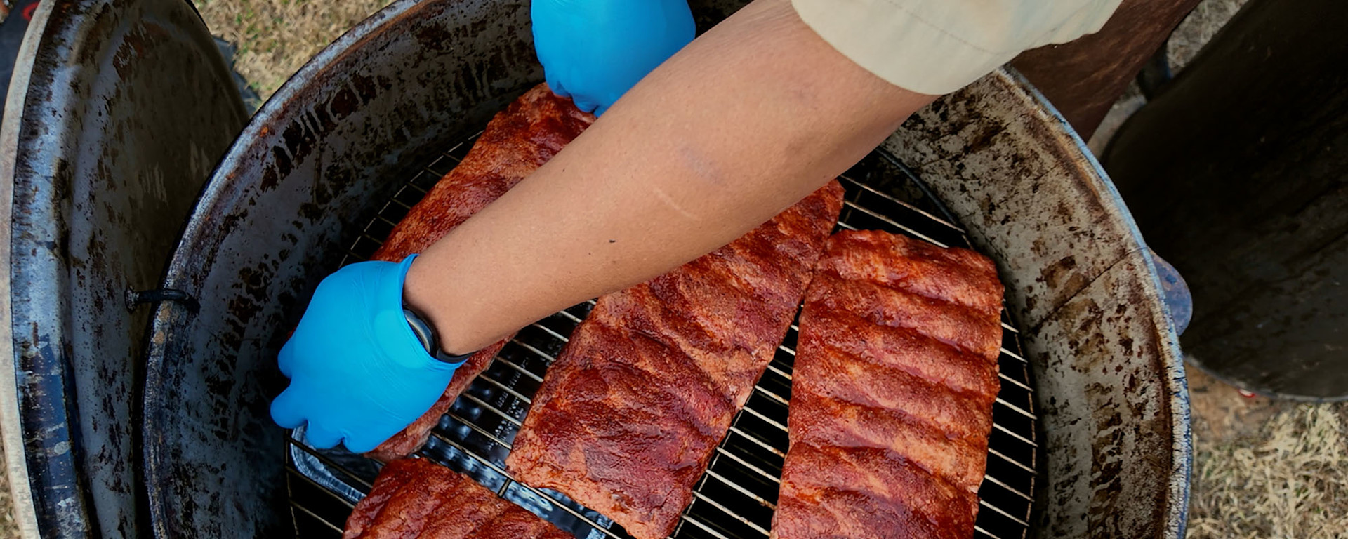 Placing ribs in the smoker to cook