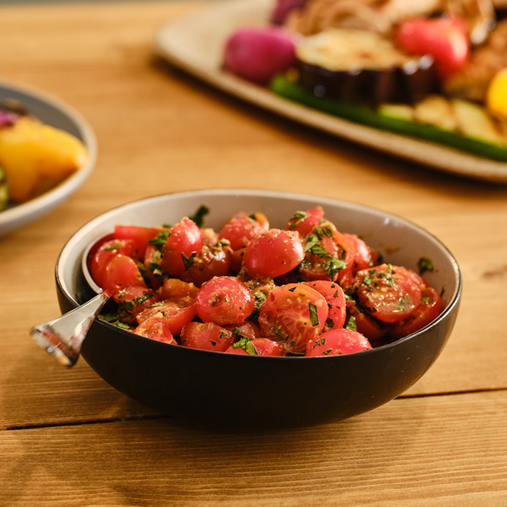 Marinated Tomatoes in a black bowl