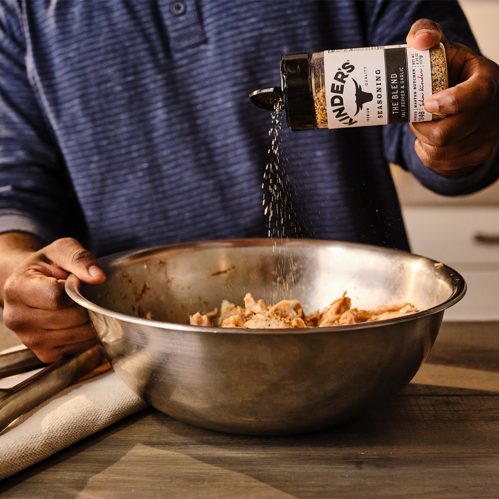 Seasoning pulled chicken with The Blend seasoning